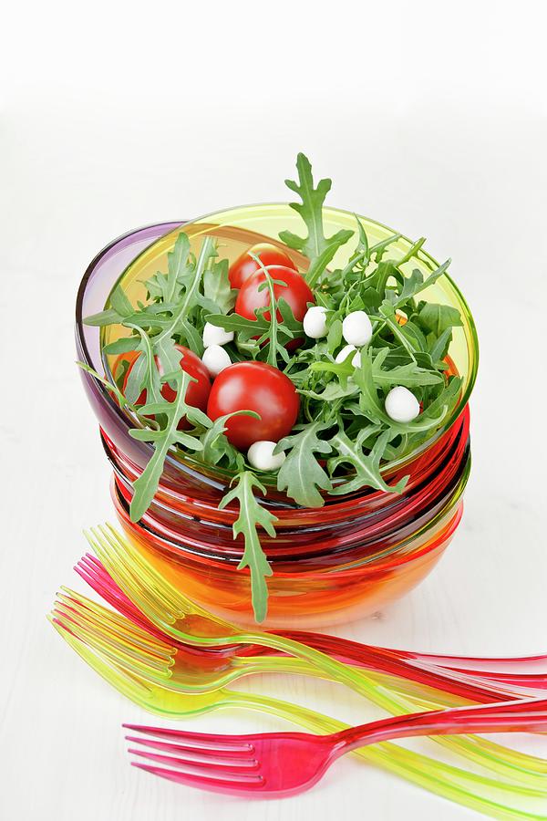 Cherry Tomatoes On A Bed Of Rocket With Mozzarella Pearls Photograph by Atelier Hmmerle
