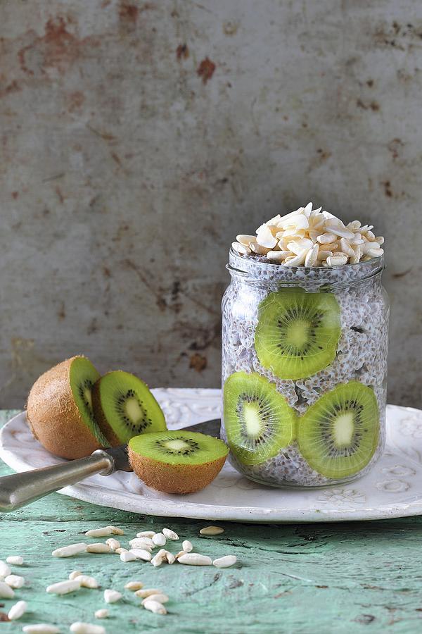 Chia Pudding With Kiwi And Almonds In A Glass Jar Photograph by Zita Csig