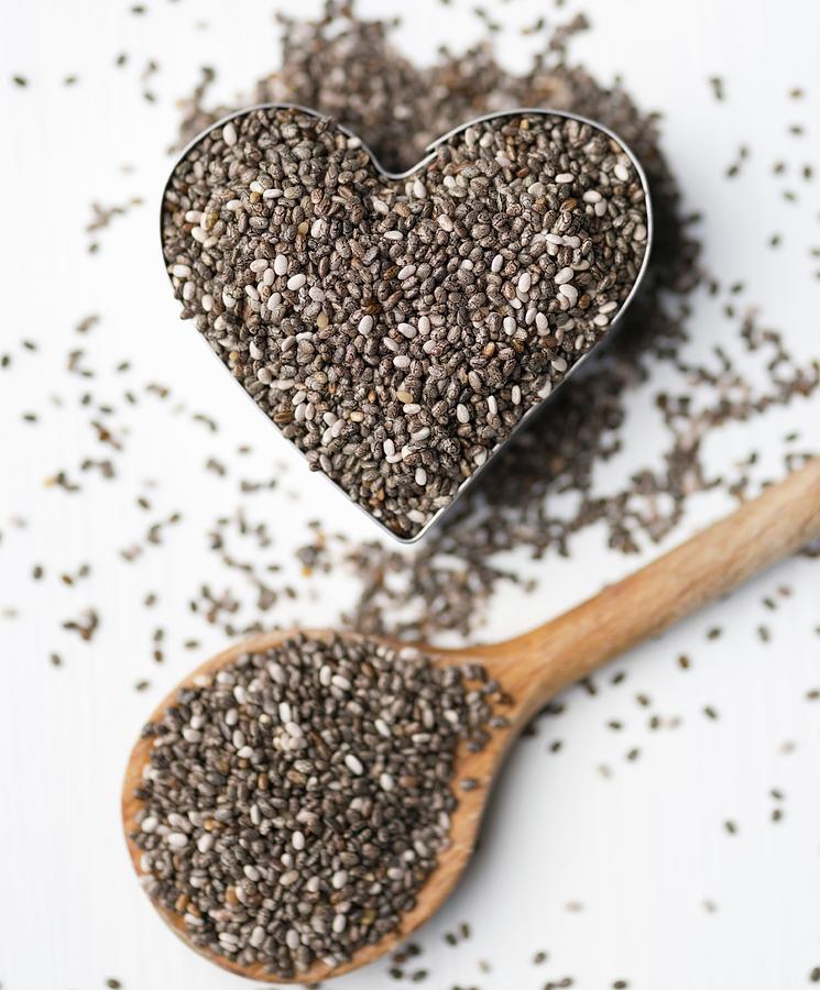 Chia Seeds In A Heart-shaped Mould And On A Wooden Spoon Photograph by Komar