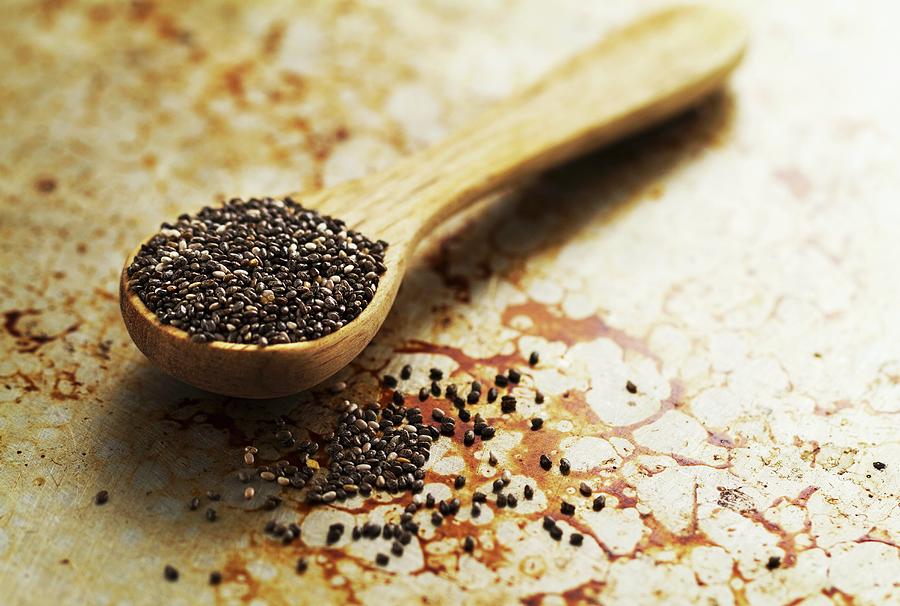 Chia Seeds In A Wooden Spoon On An Old Baking Sheet Photograph by Valeria Aksakova