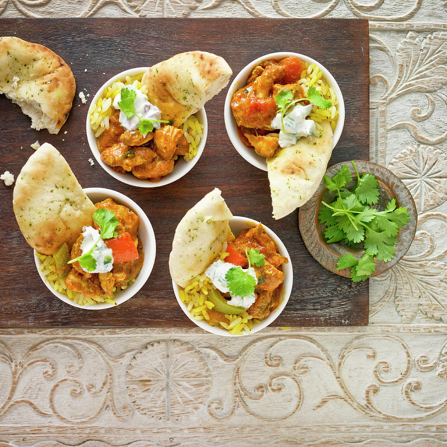 Chicken Curry And Rice Aperitifs, With Nan Bread, Yogurt Raita And Coriander Photograph by Clive Sherlock