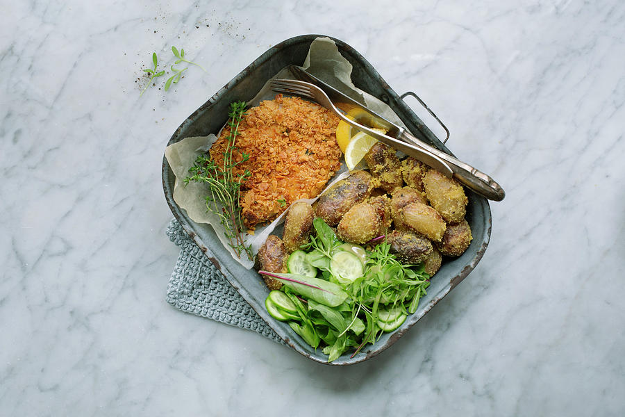 Chicken Escalope With A Cornflake Coating, Polenta Potatoes And Salad In A Baking Tin Photograph by Tina Engel