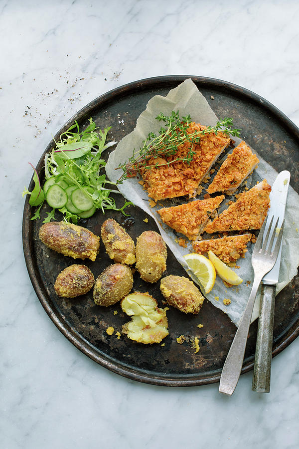 Chicken Escalope With A Cornflake Coating, Polenta Potatoes And Salad On A Round Baking Tray Photograph by Tina Engel