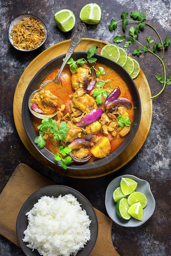 Chicken Massaman Curry With Rice And Limes Photograph by Emily Clifton