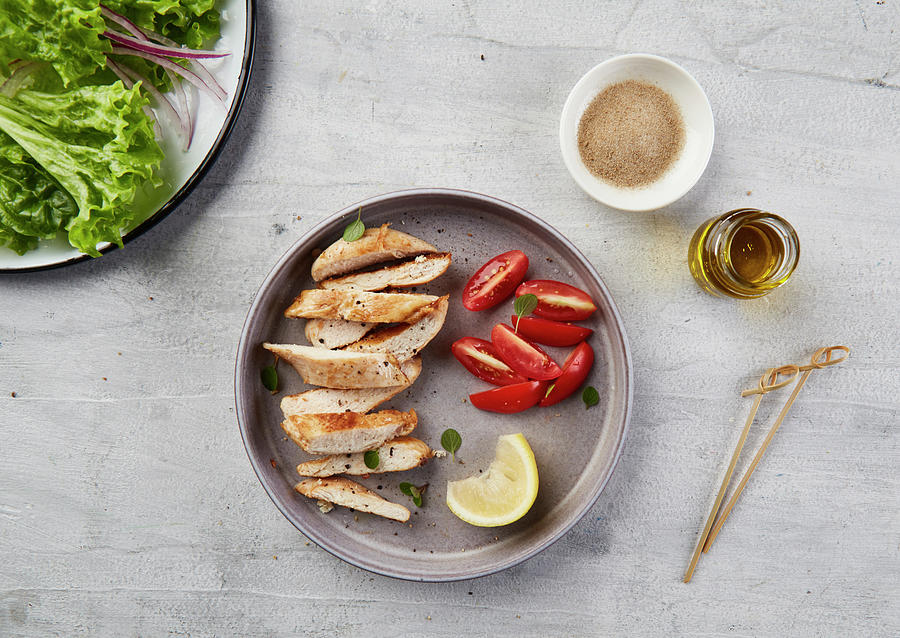 Chicken Strips On Gray Plate With Tomato, Herbs And Lemon. Photograph by Yumpic Studio
