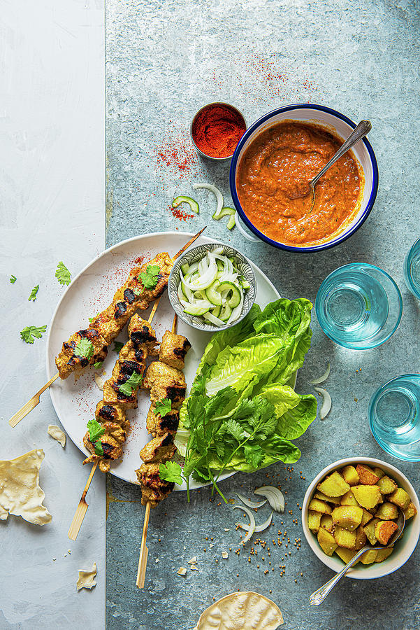Chicken Tikka Skewers With Masala Sauce, Bombay Potatoes, Pickled Onion And Cucumber Salad And Crunchy Lettuce Photograph by Magdalena Hendey