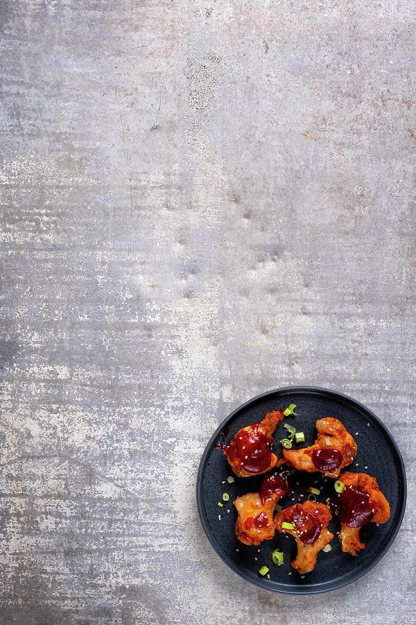 Chicken Wings With A Barbecue Sauce And Spring Onions Photograph by Adrian Britton