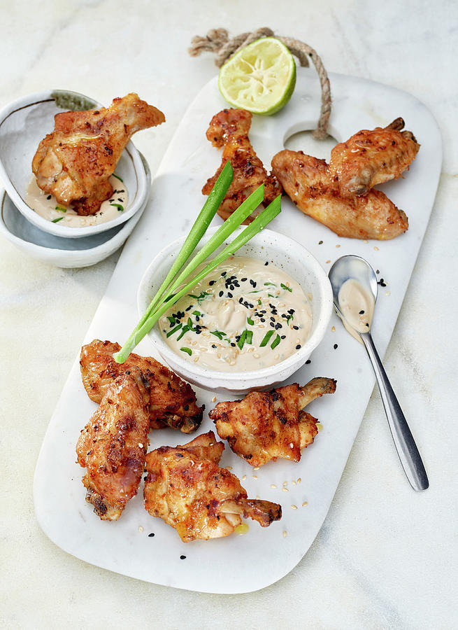 Chicken Wings With A Soya Poke Mayonnaise On A White Marble Board Photograph by Stefan Schulte-ladbeck