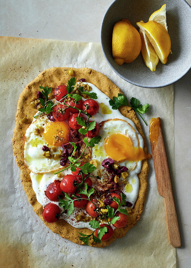 Chickpea Flour Flatbread Topped With Garlicky Yoghurt, Fried Eggs, Vine Tomatoes And Olives Photograph by Great Stock!