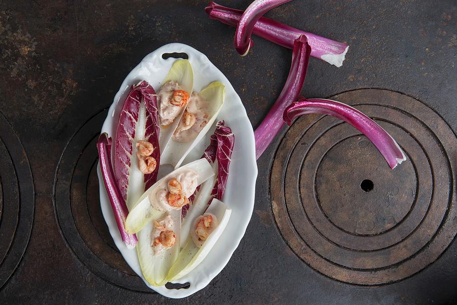 Chicory And Radicchio With Crab Mayonnaise And Shrimps In A Porcelain Bowl On A Cast-iron Pan Photograph by Angelika Grossmann