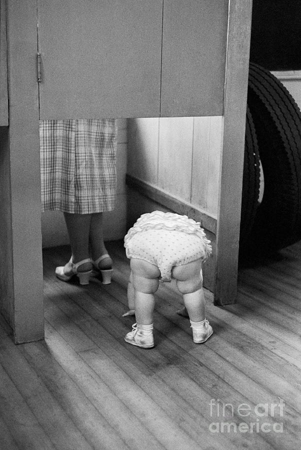 Child Peeking Under Voting Booth Photograph by Bettmann