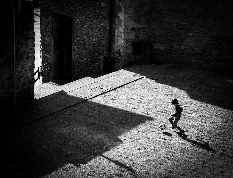 Kid Photograph - Child Playing Football by Adolfo Urrutia
