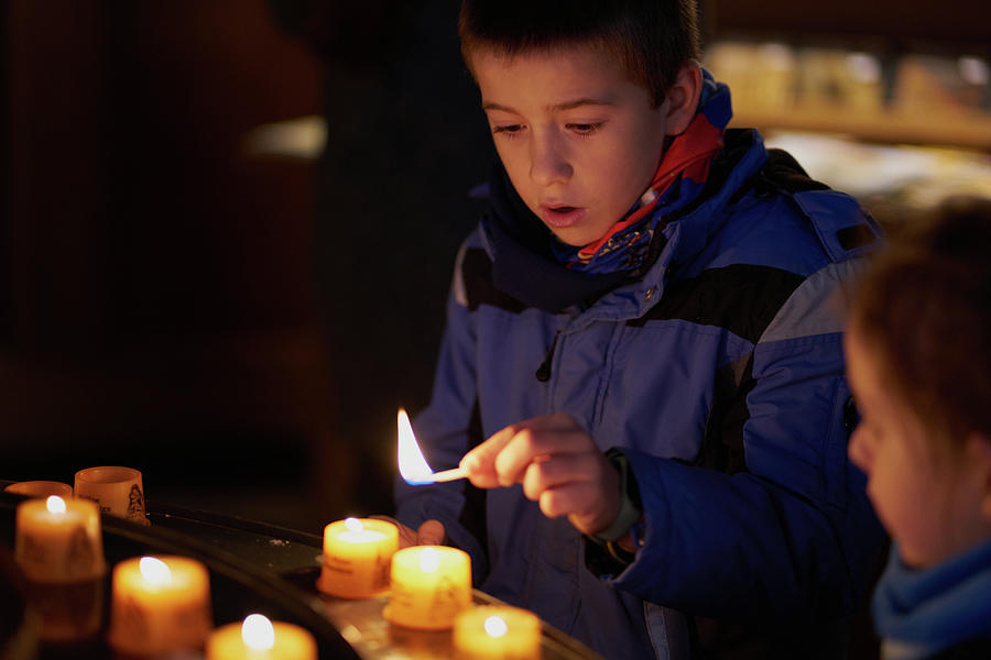 Child With A Match Is Going To Light A Candle Inside A Church ...