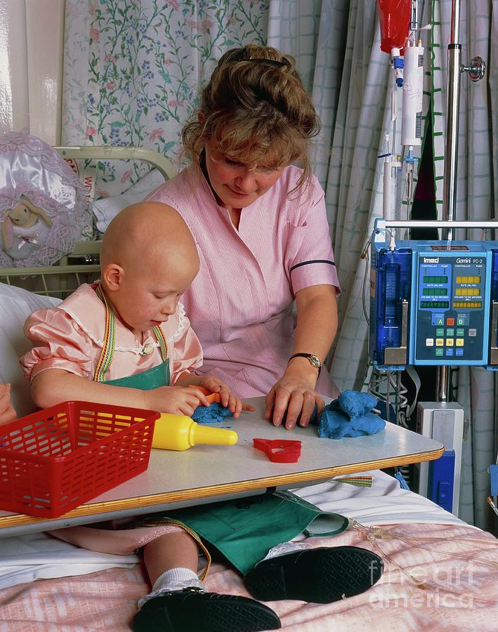 Child With Ewings Sarcoma Playing In A Nursery Photograph by Simon Fraser/royal Victoria Infirmary/science Photo Library