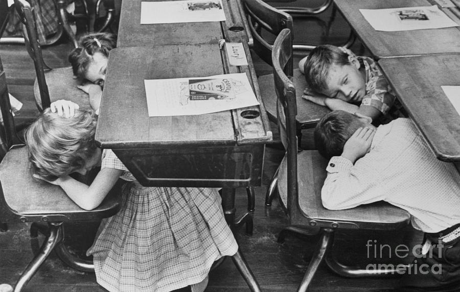 Children Ducking Under Desks Photograph by Bettmann