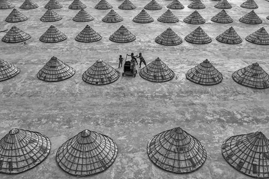 Black And White Photograph - Children In Rice Mill by Azim Khan Ronnie