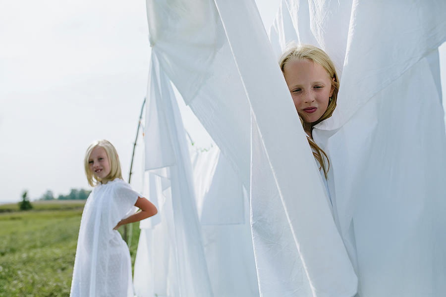 Summer Photograph - Children In The Village Play Hide And Seek Among The Washed White Line by Cavan Images