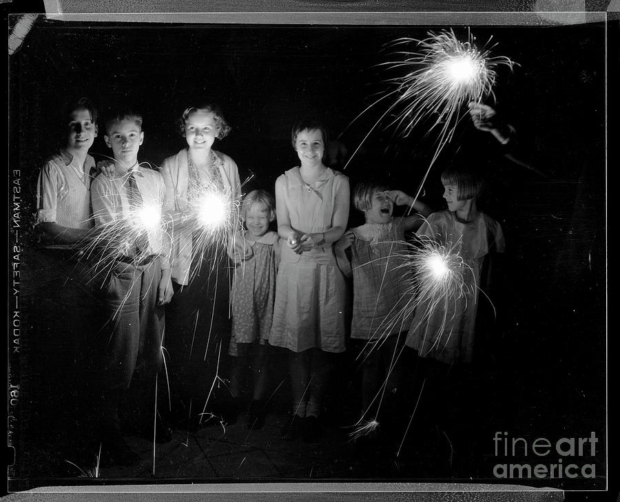 Children Laughing And Holding Sparklers Photograph by Bettmann