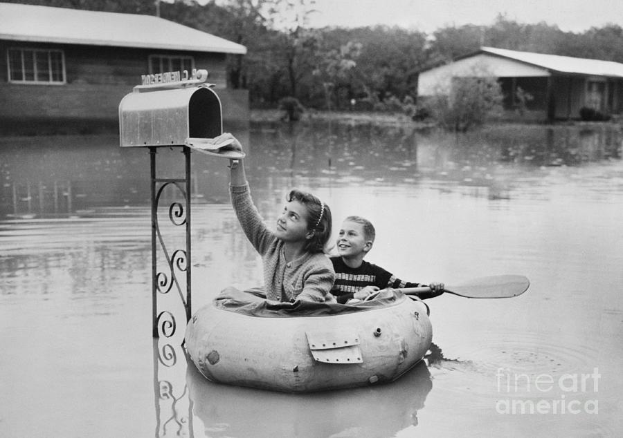 Children Picking Up Mail By Boat Photograph by Bettmann