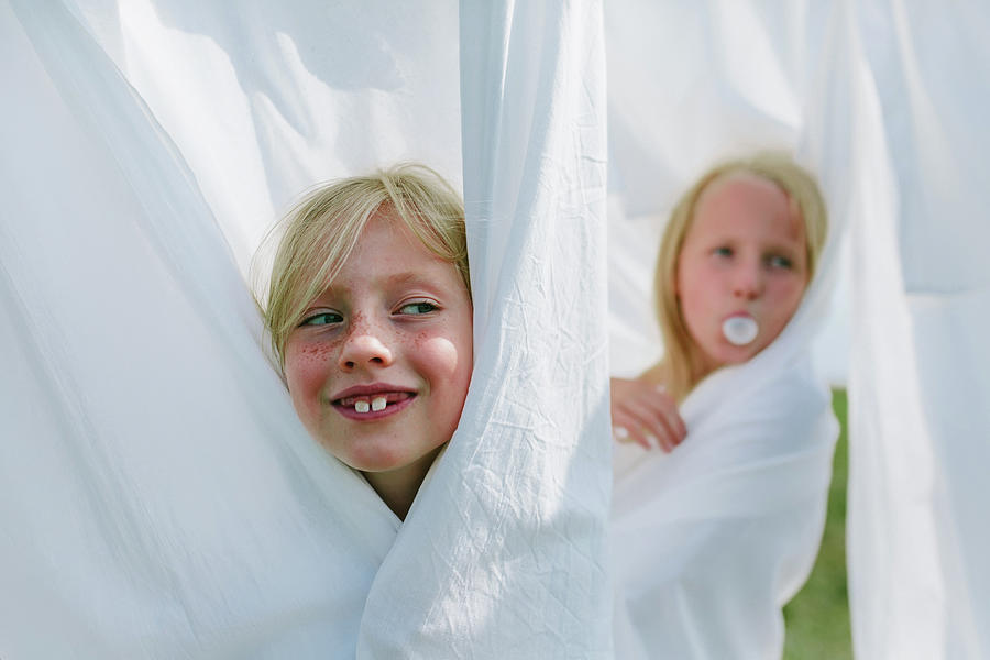 Summer Photograph - Children Play Hide And Seek Among The Washed Bed Linen by Cavan Images