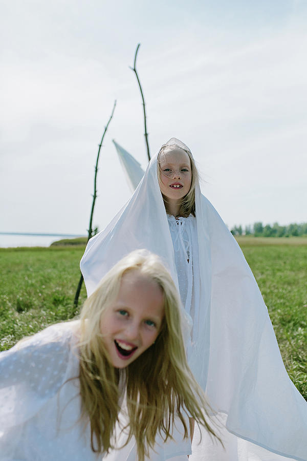Summer Photograph - Children Play With Sheets In The Summer In The Field by Cavan Images