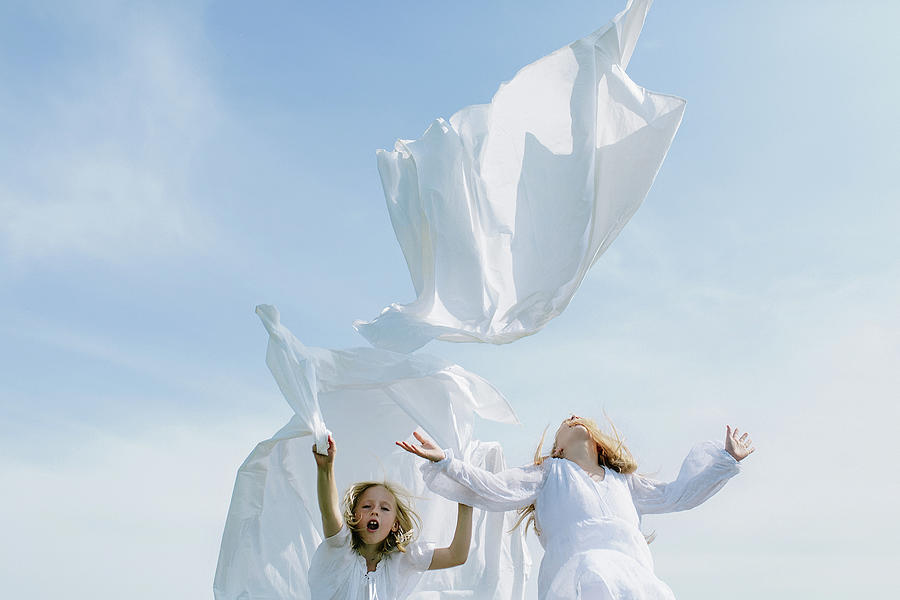 Summer Photograph - Children Throw Washed Sheets Into The Sky by Cavan Images