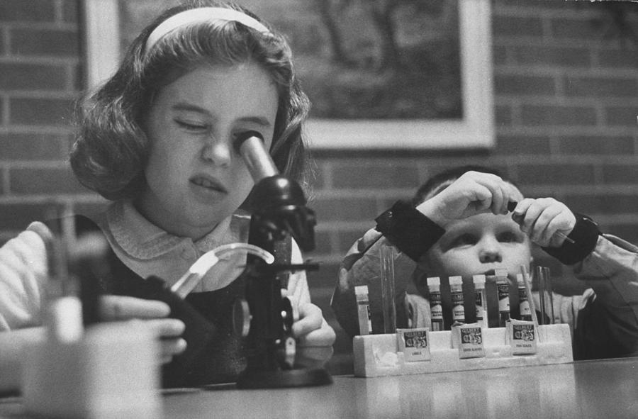 Children using a microscope set at home. Photograph by Robert Kelley