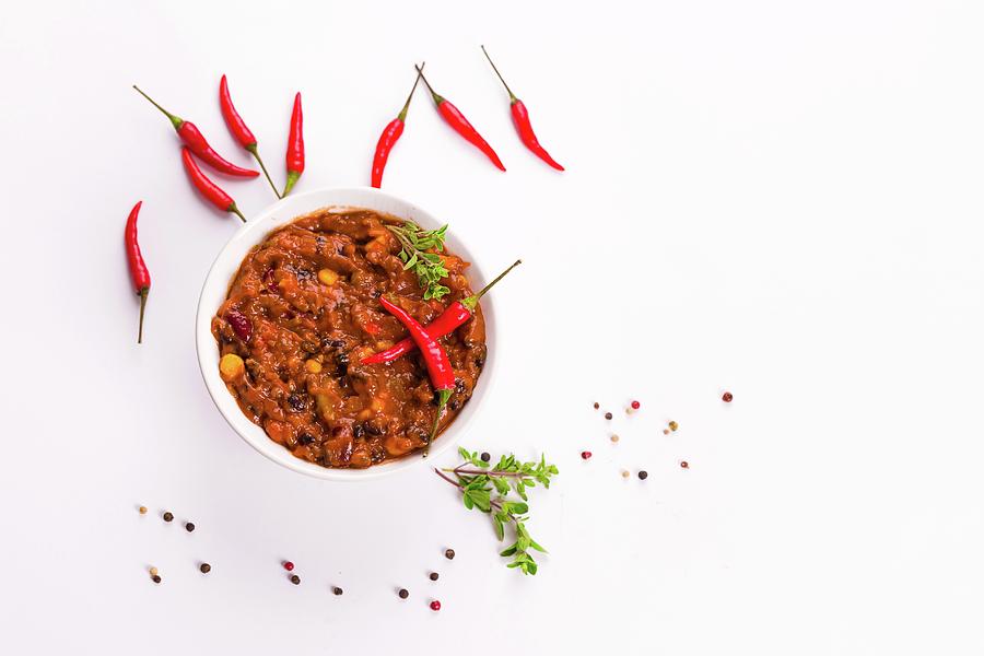 Chilli Con Carne And Fresh Whole Chillies Photograph by Christian Fischer