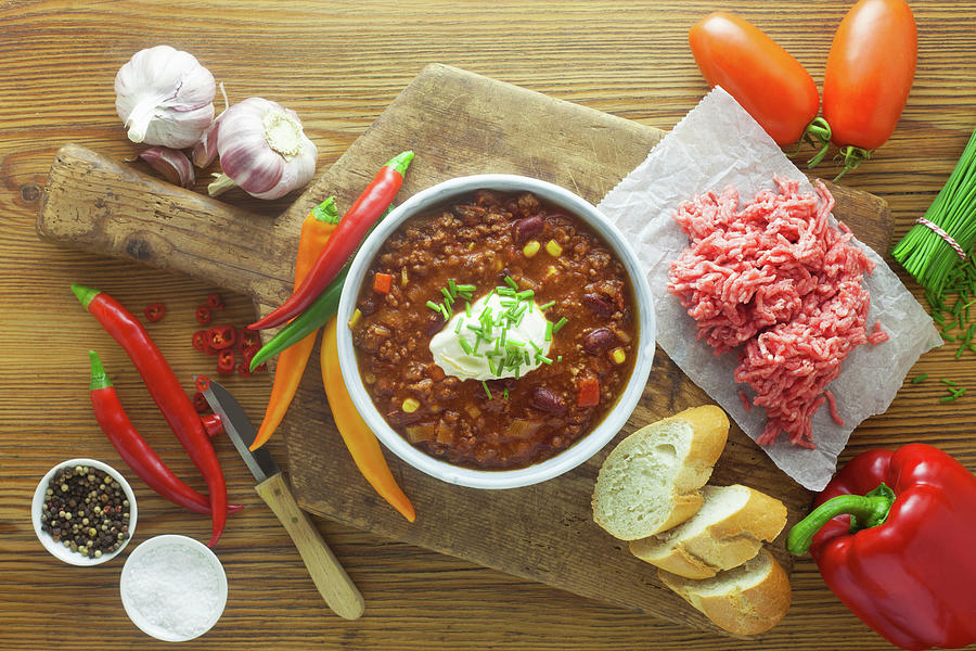 Chilli Con Carne With Ingredients On A Wooden Surface Photograph by Barbara Pheby