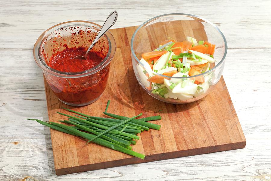 Chilli Paste, Sliced Vegetables And Spring Onions On A Chopping Board Photograph by Rua Castilho