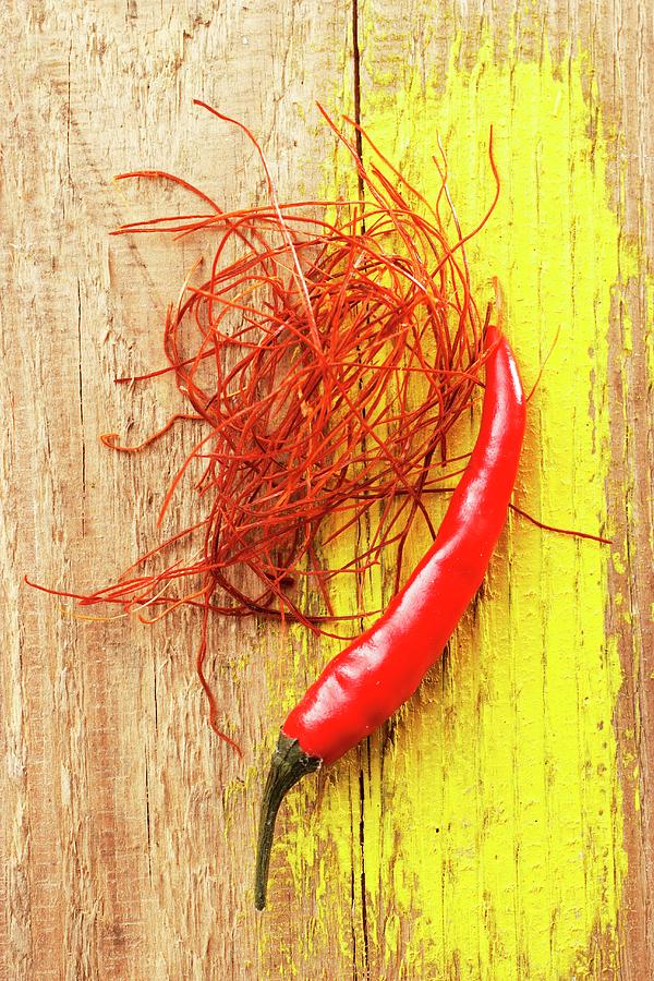 Chilli Strands And A Fresh Whole Chilli Photograph by Petr Gross