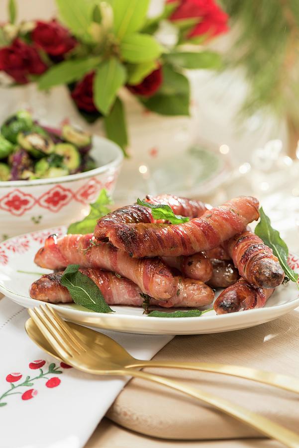Chipolatas Wrapped In Bacon With Ginger Syrup For Christmas Dinner Photograph by Winfried Heinze