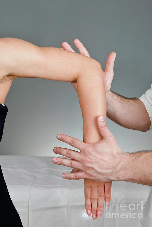 Chiropractor Examining Patients Arm Photograph by Microgen Images/science Photo Library