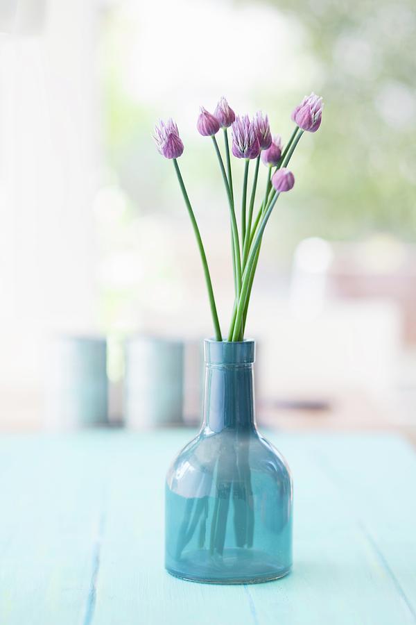Chive Flowers In Blue Glass Vase Photograph by Jan Wischnewski
