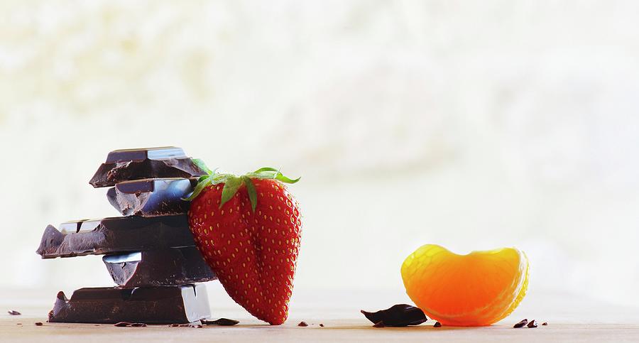 Chocolate, A Strawberry And A Wedge Of Orange Photograph by Nele Braas