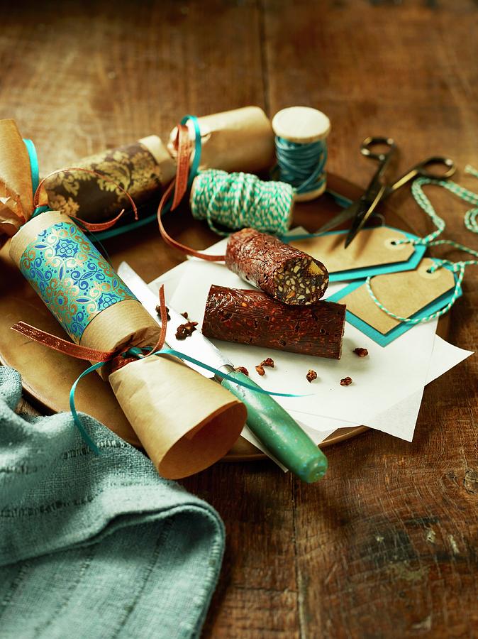 Chocolate And Dried Fruit Rolls In Christmas Cracker Wrappings Photograph by Dan Jones