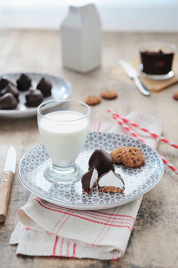 Chocolate And Meringue Drops And A Glass Of Milk Photograph by Syl D Ab