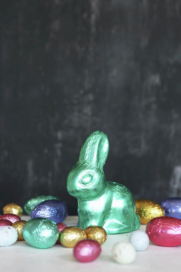 Chocolate Bunny And Eggs Wrapped In Colourful Shiny Foil Photograph by Thordis Rggeberg