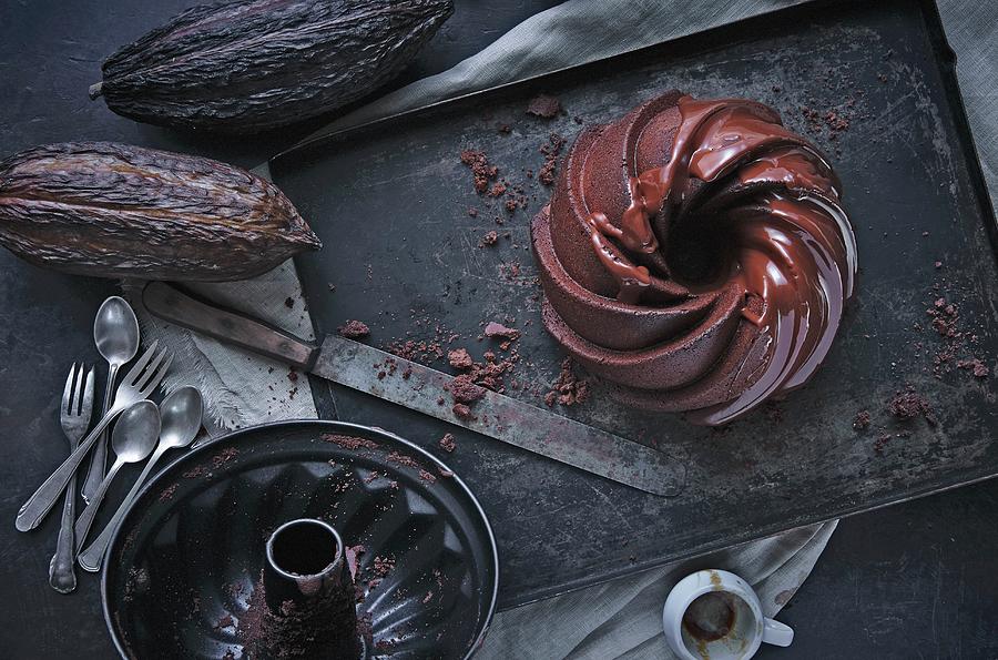 Chocolate Cake, A Baking Tray And Cacoa Pods Photograph by Kai Stiepel