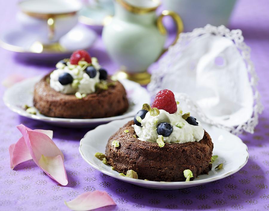 Chocolate Cake Filled With Vanilla Ice Cream, Berries And Pistachio Nuts Photograph by Mikkel Adsbl