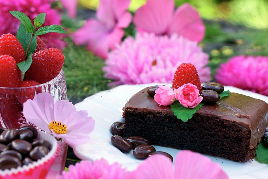 Chocolate Cake On A Dessert Plate Among Pink Floral Decorations Photograph by Angelica Linnhoff