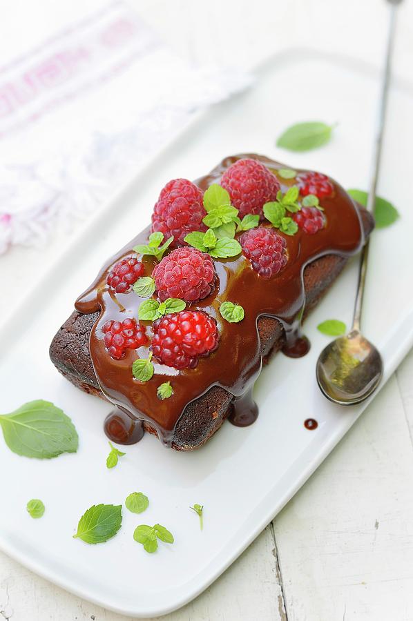 Chocolate Cake Topped With A Fresh Raspberries And Mint Photograph by Keroudan