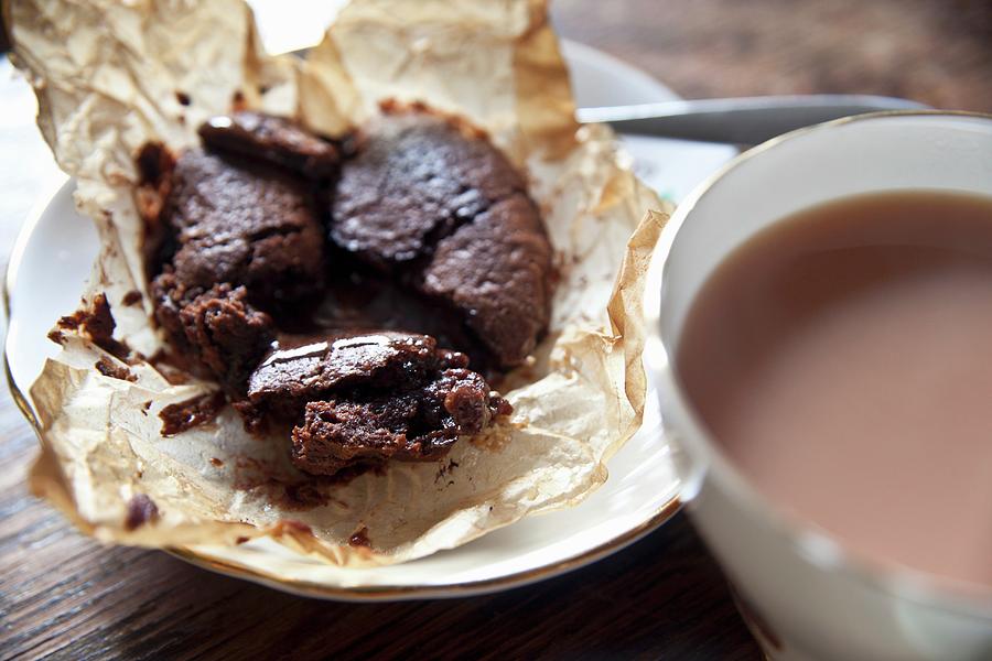 Chocolate Cake With A Liquid Centre Served With A Cup Of Tea Photograph by George Blomfield