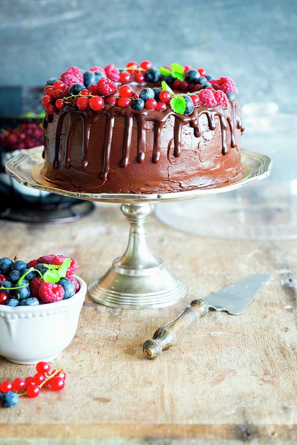 Chocolate Cake With Chocolate Buttercream Decorated With Fresh Berries And Mint Photograph by Irina Meliukh