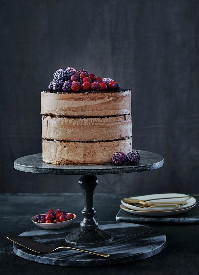 Chocolate Cake With Chocolate Cream, Frozen Blackberries And Cranberries Photograph by Nina Struve