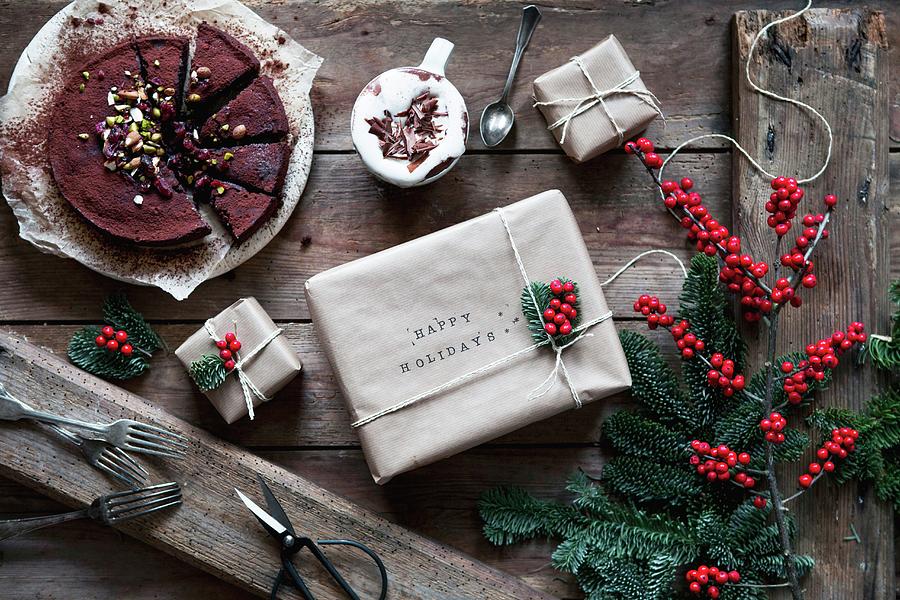 Chocolate Cake With Cocoa Powder Displayed Beside Christmas Presents Photograph by Claudia Gdke