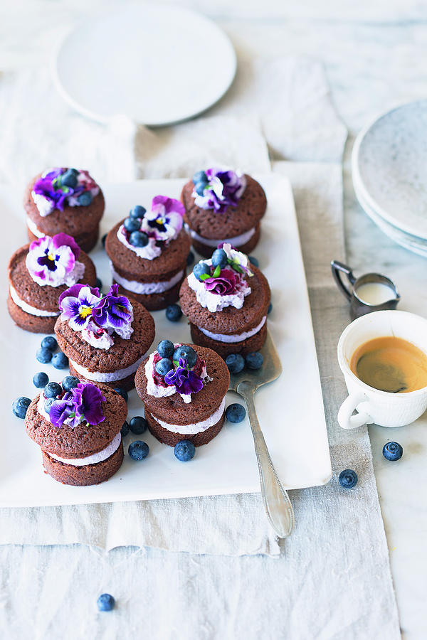 Chocolate Cakes With Blueberry Cream And Pansies Photograph by Jalag / Wolfgang Schardt