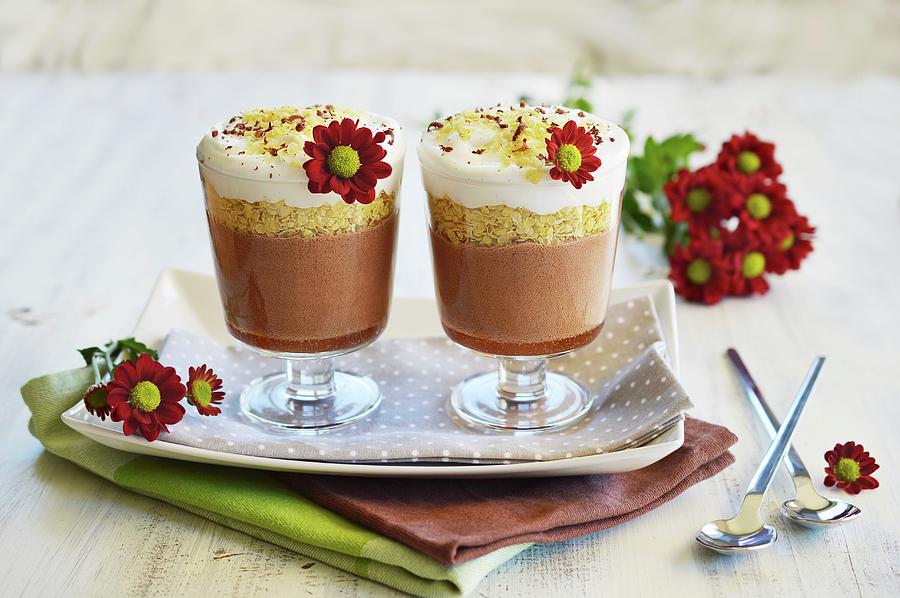 Chocolate, Cereal And Coconut Milk Desserts In Two Serving Glasses Standing Next To Each Other And Decorated With Fresh Flowers Photograph by Mariola Streim