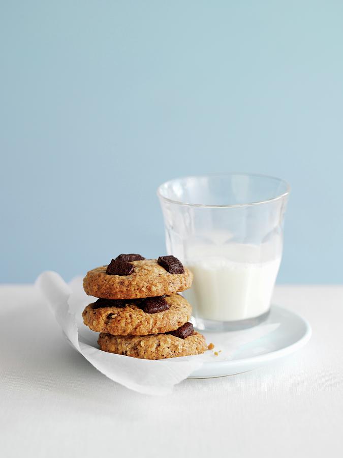Chocolate Chip And Nut Cookies With A Glass Of Milk Photograph by Gareth Morgans