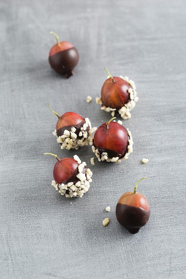 Chocolate-coated Gooseberries And Chopped Almonds Photograph by Mandy Reschke